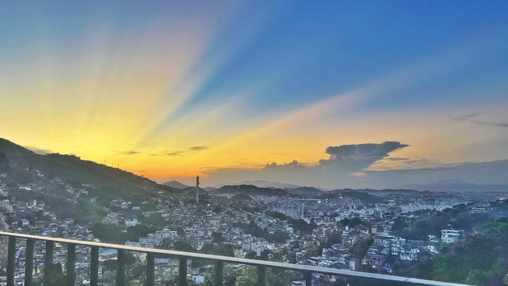 a view of a city at sunset at Cozy House in Rio de Janeiro