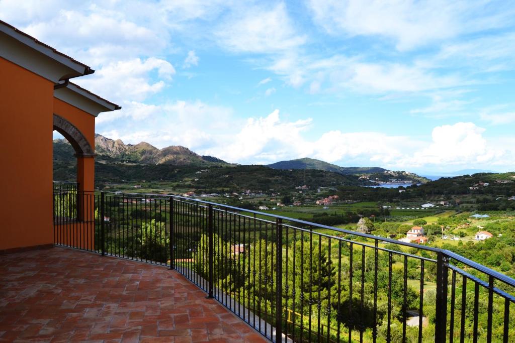 a balcony with a view of the mountains at Il Casale in Capoliveri