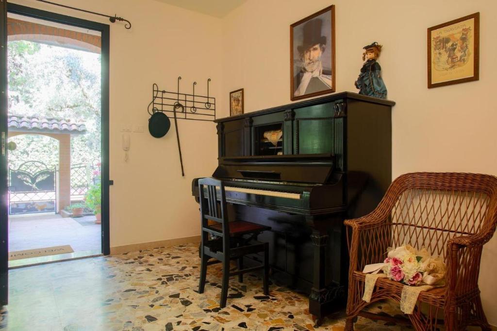 チェゼーナにあるLa Tana del Grillo Parlanteのリビングルーム(ピアノ、椅子付)