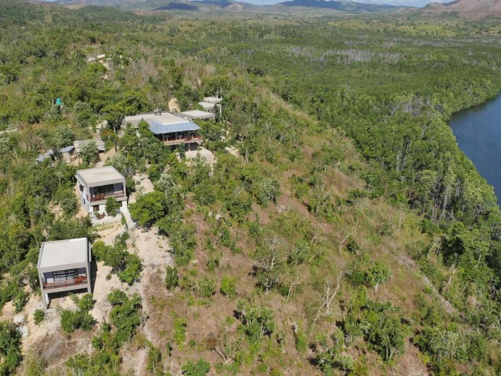 an aerial view of a house on a hill near the water at The Riverhouse in Coron
