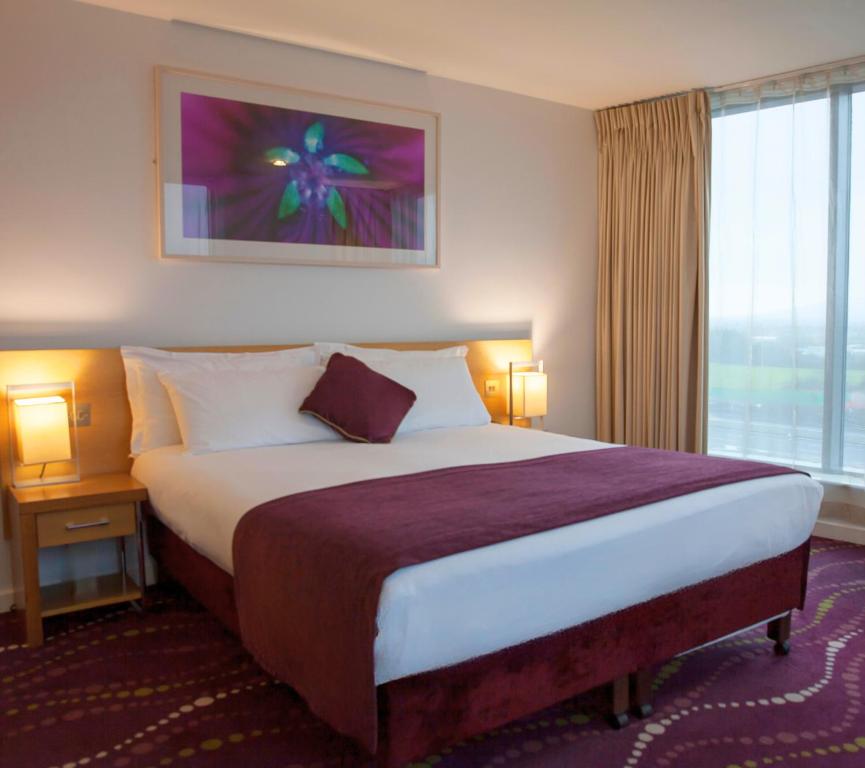 Postel nebo postele na pokoji v ubytování Louis Fitzgerald Hotel
