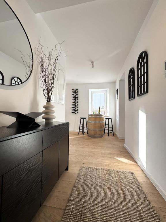 a living room with a dresser and a mirror at WeinZeit13 in Neustadt an der Weinstraße