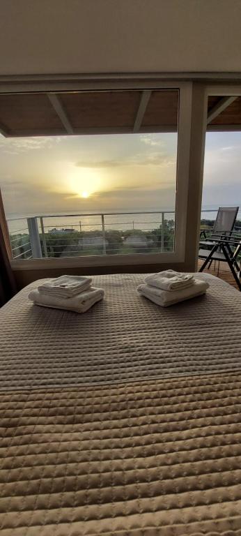a bedroom with a bed with two mattresses on it at View West Elafonisi house in Livadia