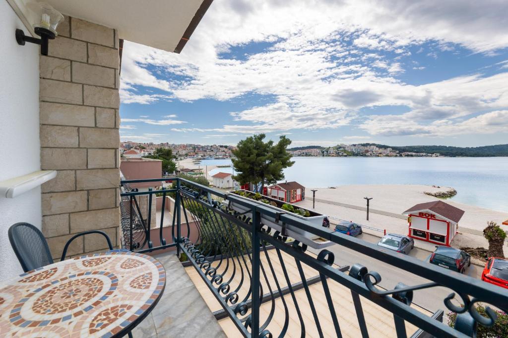 ein Balkon mit Tisch und Blick aufs Wasser in der Unterkunft Villa Okruk-10 meters away from the beach in Trogir
