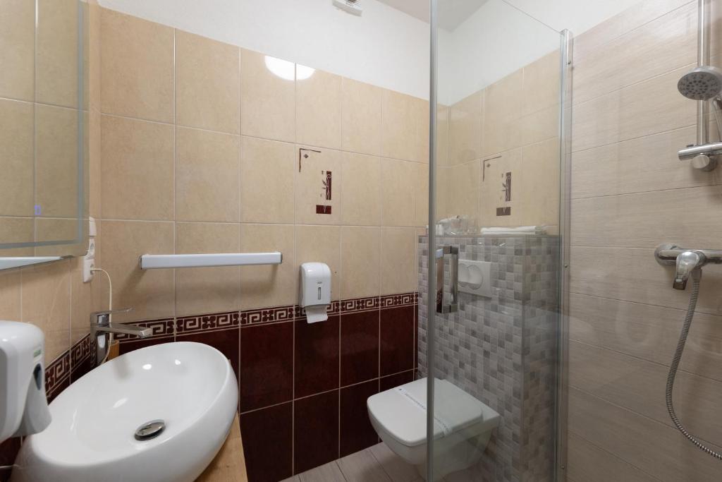ein Badezimmer mit Toilette und Glasdusche in der Unterkunft Villa Okruk-10 meters away from the beach in Trogir