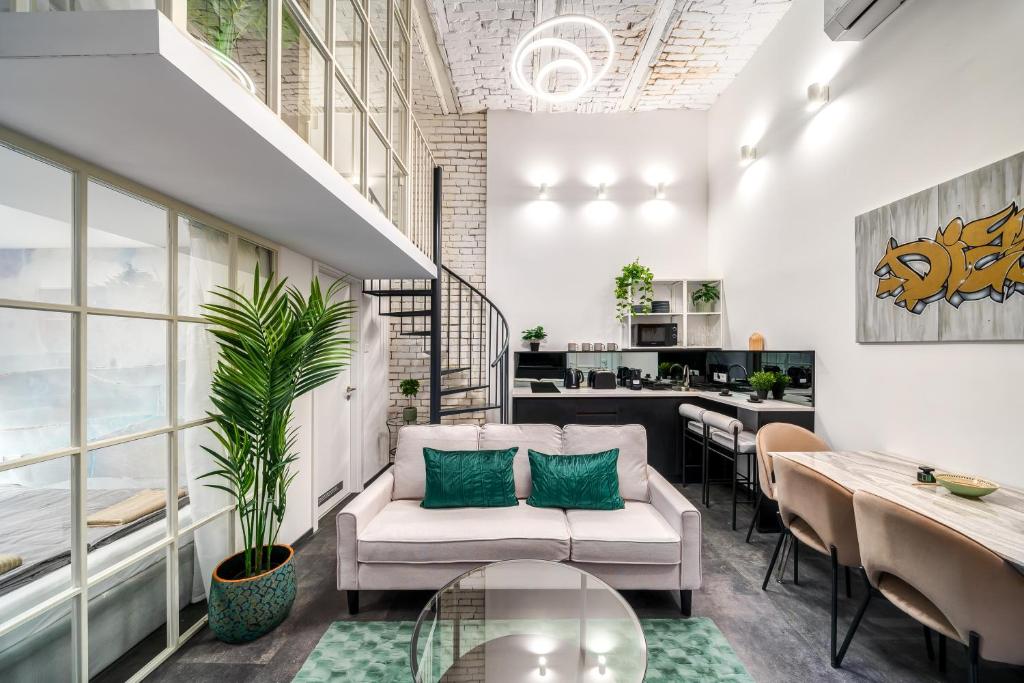 a room with a table and chairs and a counter at Paulay at Opera Suites P39 in Budapest