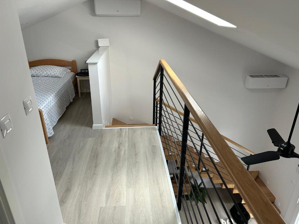 a stairway leading to a bedroom with a bed at Casa Liliana By the Sea in Mali Lošinj