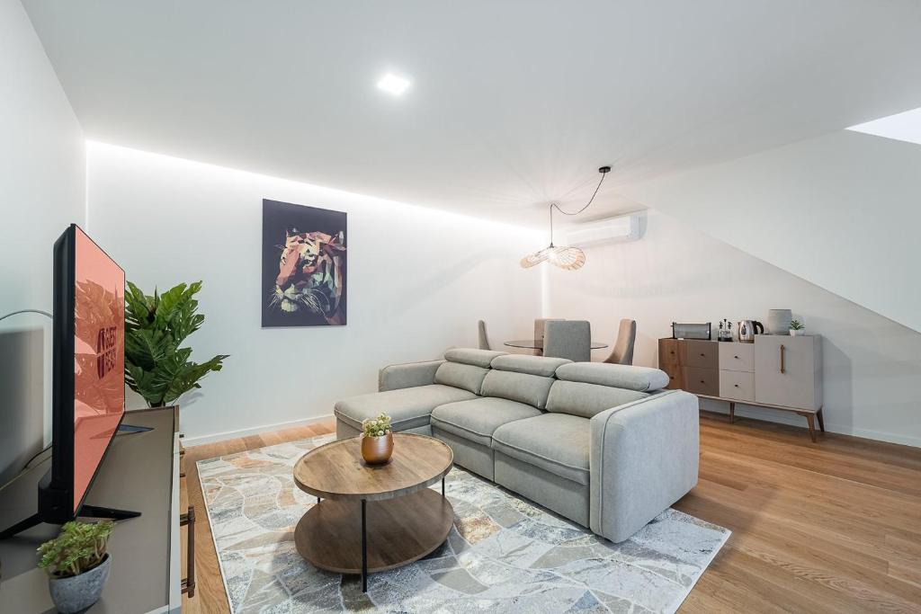 a living room with a couch and a table at GuestReady - Vera Cruz Apartments in Porto