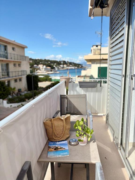a table on a balcony with a laptop on it at Hotel Miramar- Cap d'Antibes - La Garoupe plage in Antibes