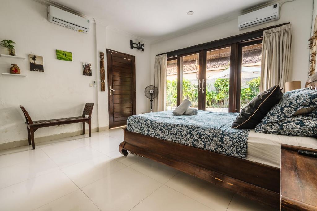 Uma cama ou camas num quarto em Sari Temuku Villa