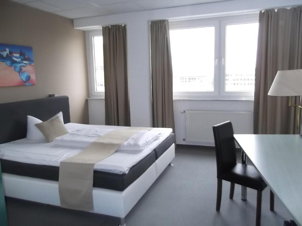 Postel nebo postele na pokoji v ubytování Businesshotel & Appartements Stuttgart-Vaihingen