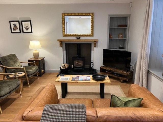 a living room with a couch and a table at Balnain Street Cottage in Inverness