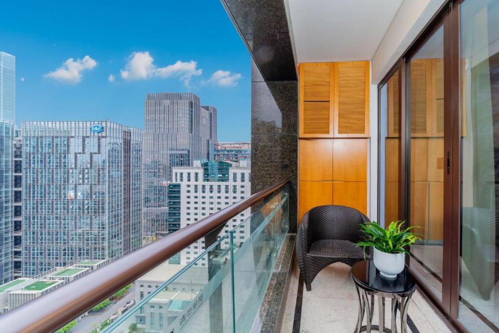 a balcony with a chair and a view of a city at Fa万濠国际服务公寓 in Guangzhou