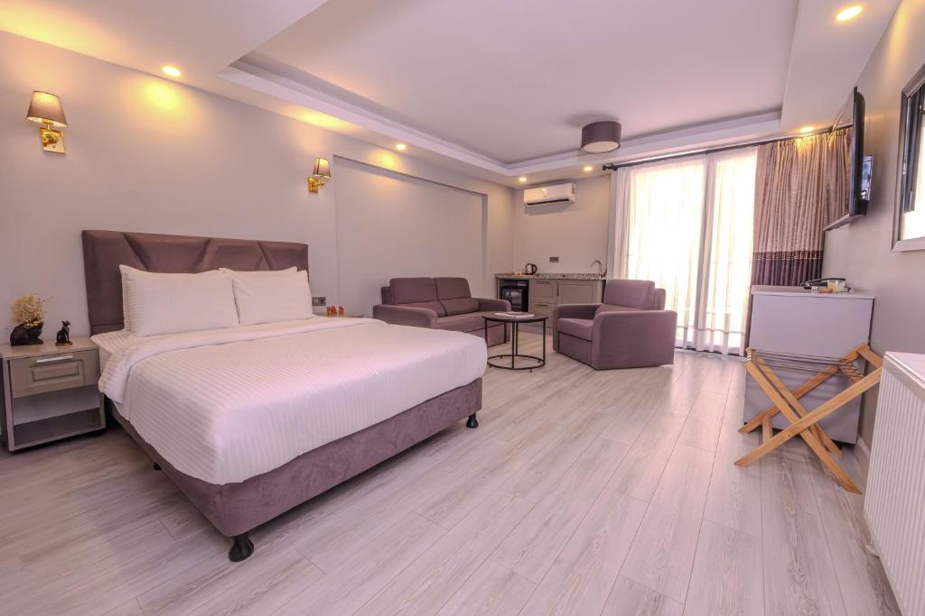 a hotel room with a bed and a living room at Rubby Kadıköy in Istanbul