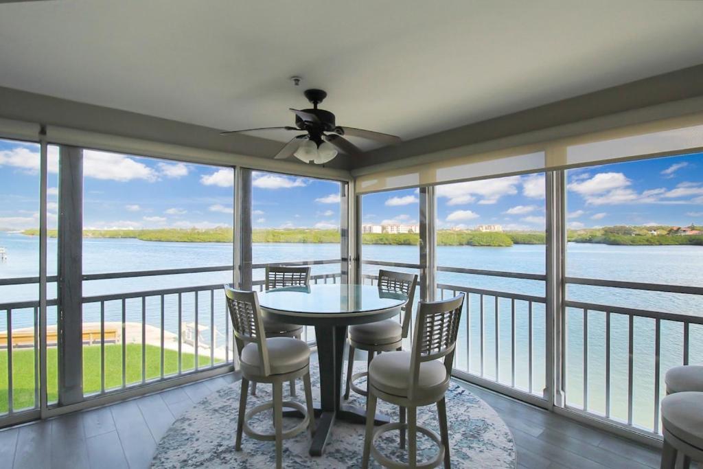a dining room with a view of the water at Bayfront 3BR 2nd floor Siesta Key condo with private beach access in Siesta Key
