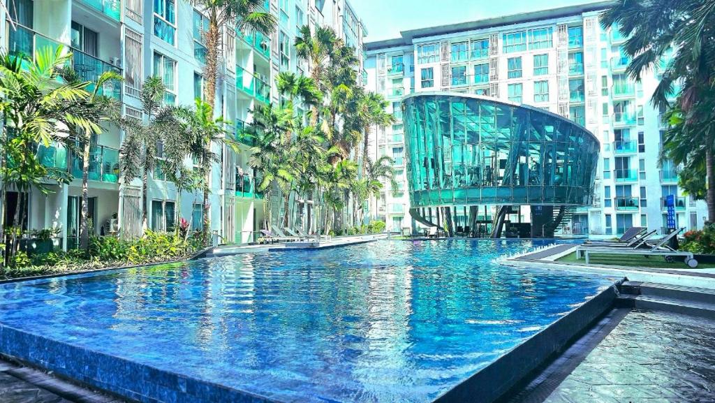 a large swimming pool in a city with buildings at City Center Residence NEW in Pattaya