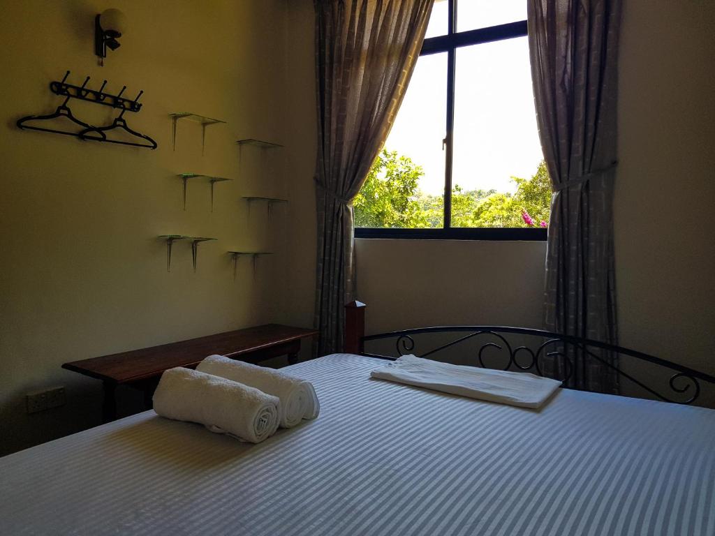 a bedroom with two beds with towels on them at Lush Breeze Mount View in Kandy