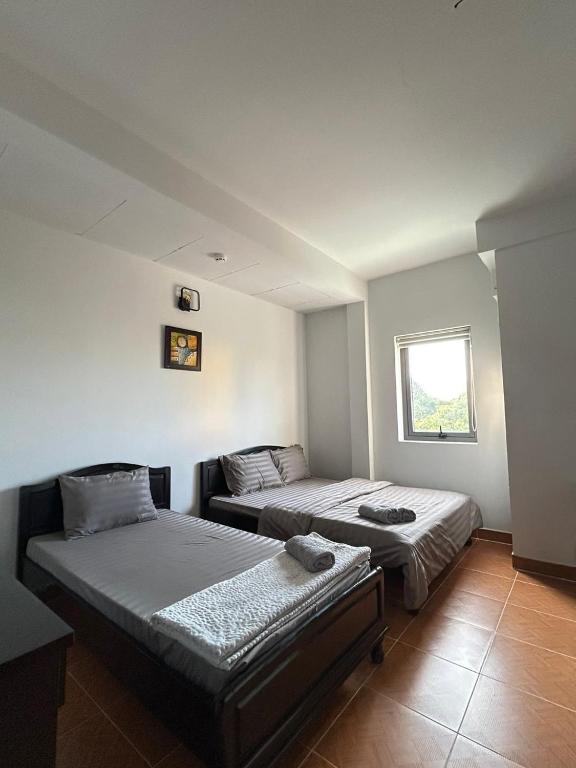 Postel nebo postele na pokoji v ubytování Ruby Căn hộ Dịch vụ Khách sạn