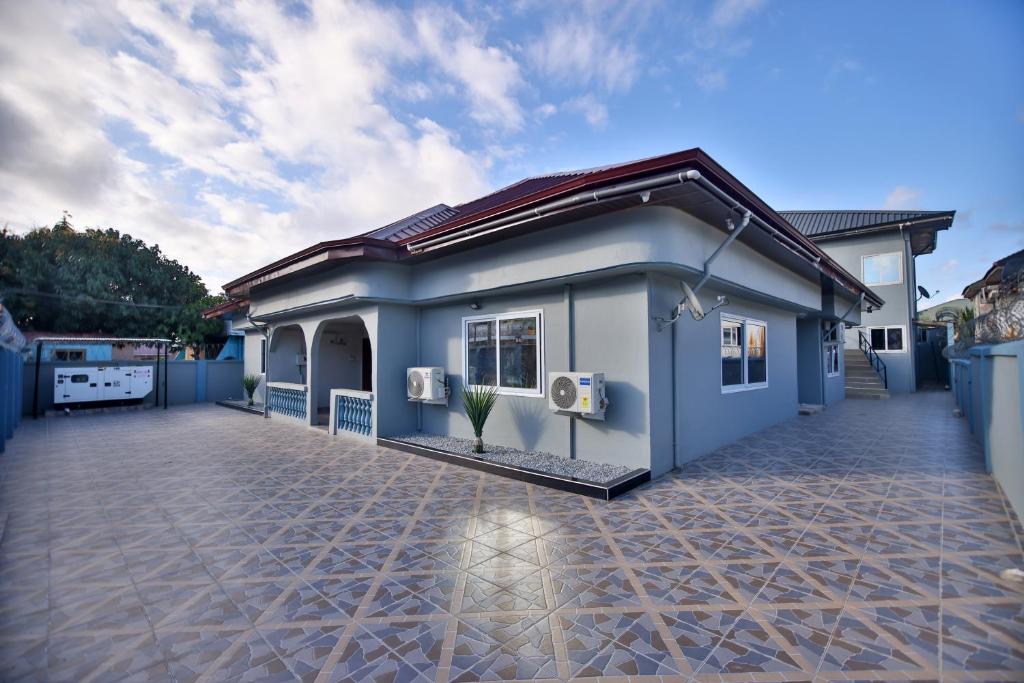 a rendering of a small blue house at The Everette Lodge in Sekondi-Takoradi