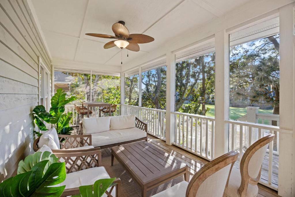 a porch with a couch and chairs and a ceiling fan at SM05: 5 Silver Moss in Kiawah Island