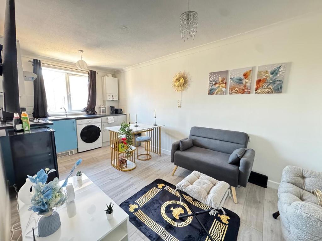 a living room with a couch and a chair at Cosy Retreat in Greenwich