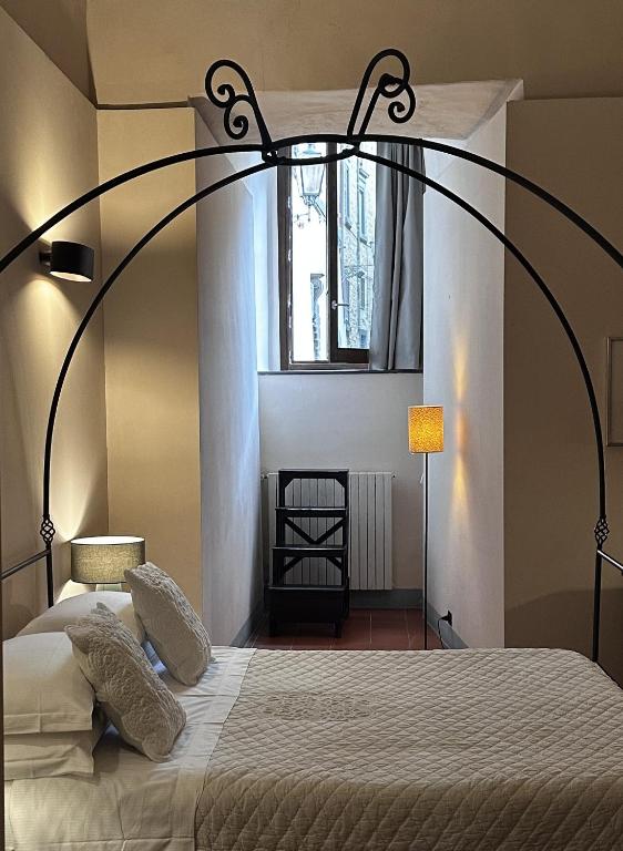 Postel nebo postele na pokoji v ubytování Hotel Palazzo Piccolomini