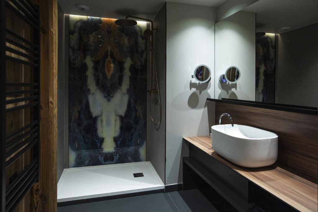 a bathroom with a sink and a shower at Hotel Beauregard in La Clusaz