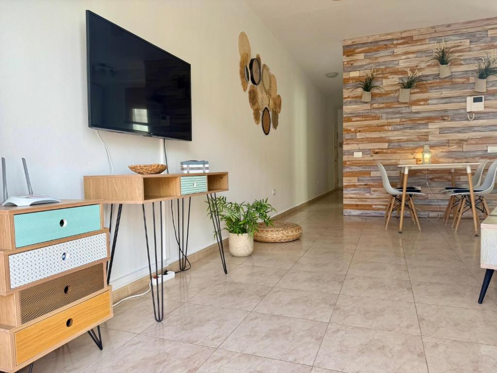 A television and/or entertainment centre at Dominos Apartment with heated pool by SunHousesCanarias
