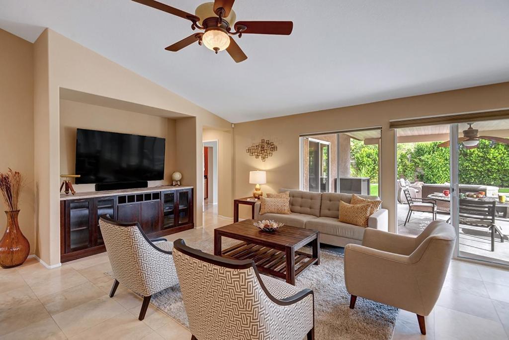 a living room with a couch and a tv at Quiet & Quite Perfect in Palm Desert