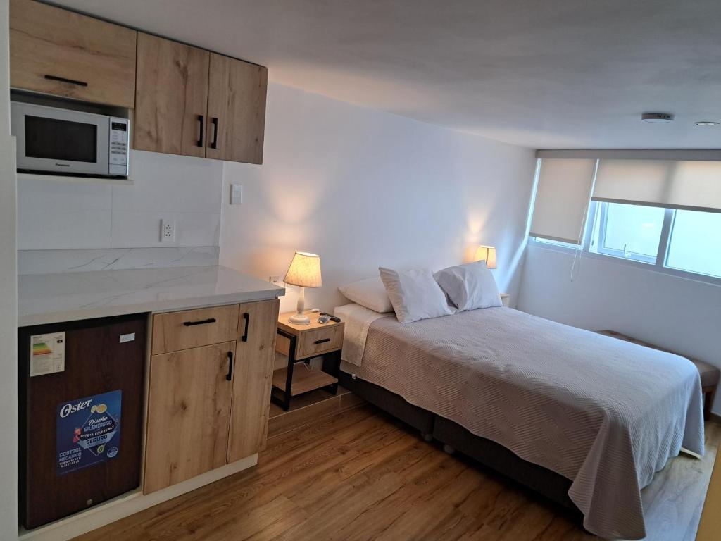 Ένα ή περισσότερα κρεβάτια σε δωμάτιο στο Venue Apartments