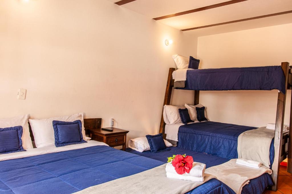 Cama o camas de una habitación en HOTEL RUTA 40 VILLA DE LEYVA