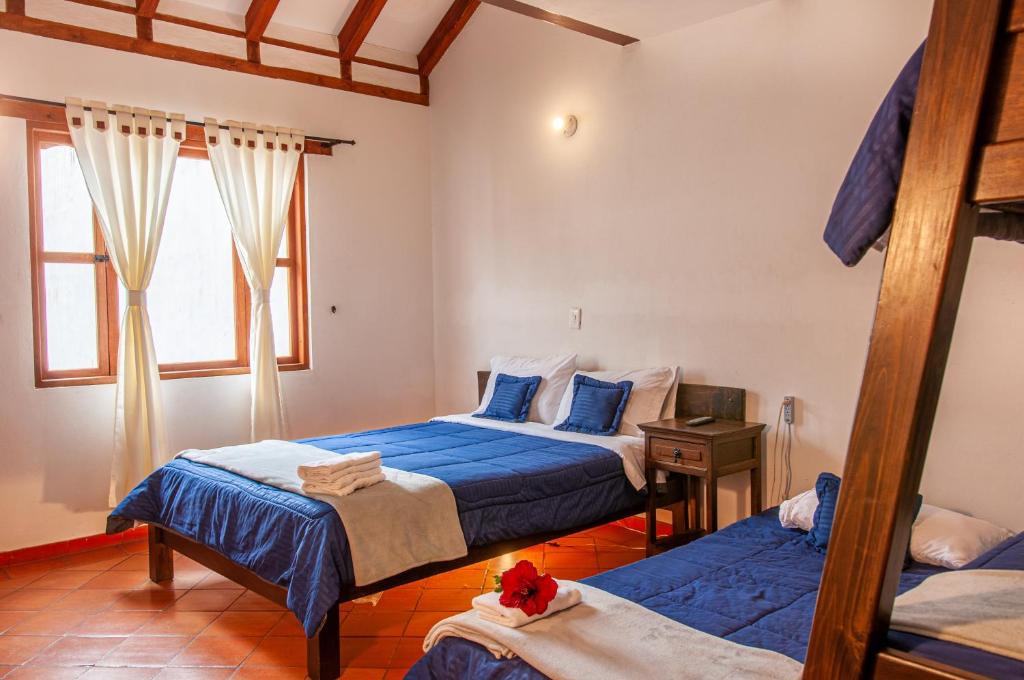 Cama o camas de una habitación en HOTEL RUTA 40 VILLA DE LEYVA