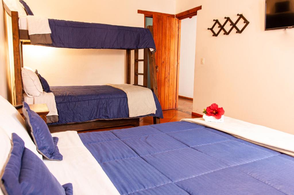 Cama o camas de una habitación en HOTEL RUTA 40 VILLA DE LEYVA