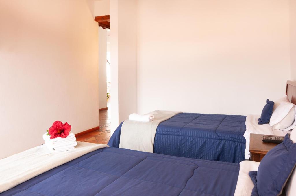 Cama o camas de una habitación en HOTEL RUTA 40 VILLA DE LEYVA