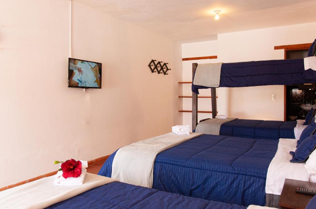 Cama o camas de una habitación en HOTEL RUTA 40 VILLA DE LEYVA