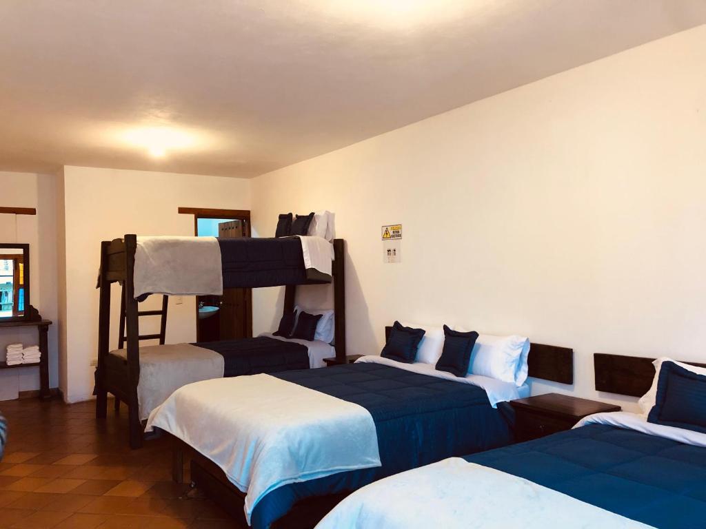 Cama o camas de una habitación en HOTEL RUTA 40 VILLA DE LEYVA