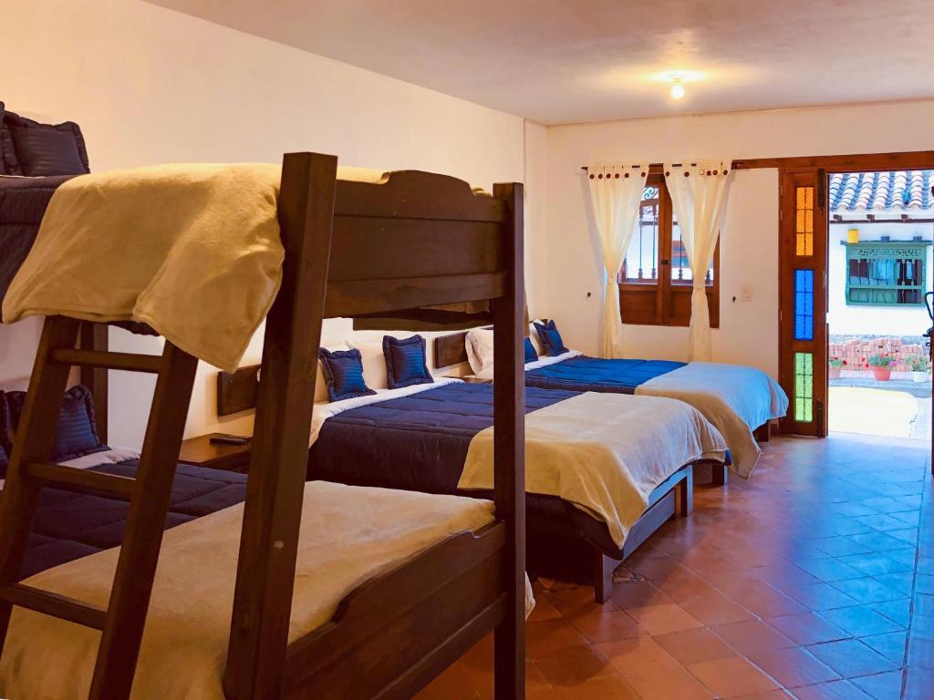 Cama o camas de una habitación en HOTEL RUTA 40 VILLA DE LEYVA
