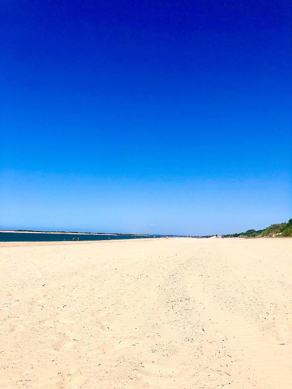 a sandy beach with a blue sky in the background at Apartamento a pie de playa en El Portil in El Portil