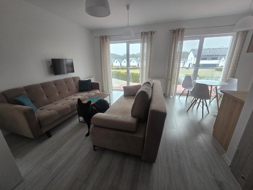a living room with a couch and a table at Słoneczny Nadmorska in Grzybowo