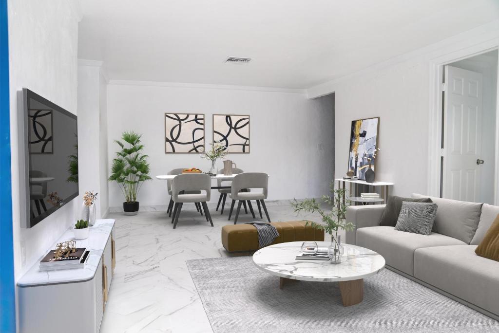 a living room with a couch and a table at University Luxe Residences in Tampa