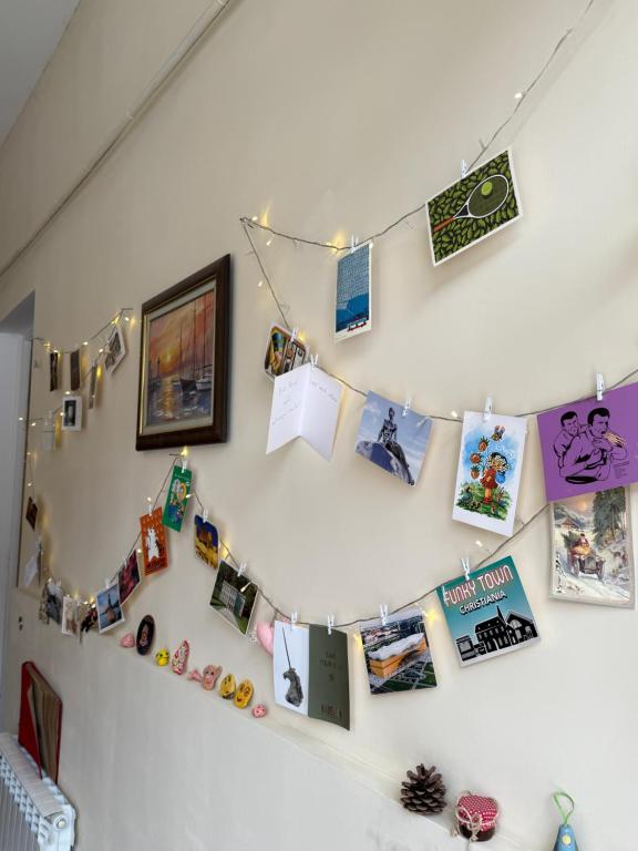 a wall with pictures and photos hanging on it at HeyTun Gyumri in Gyumri