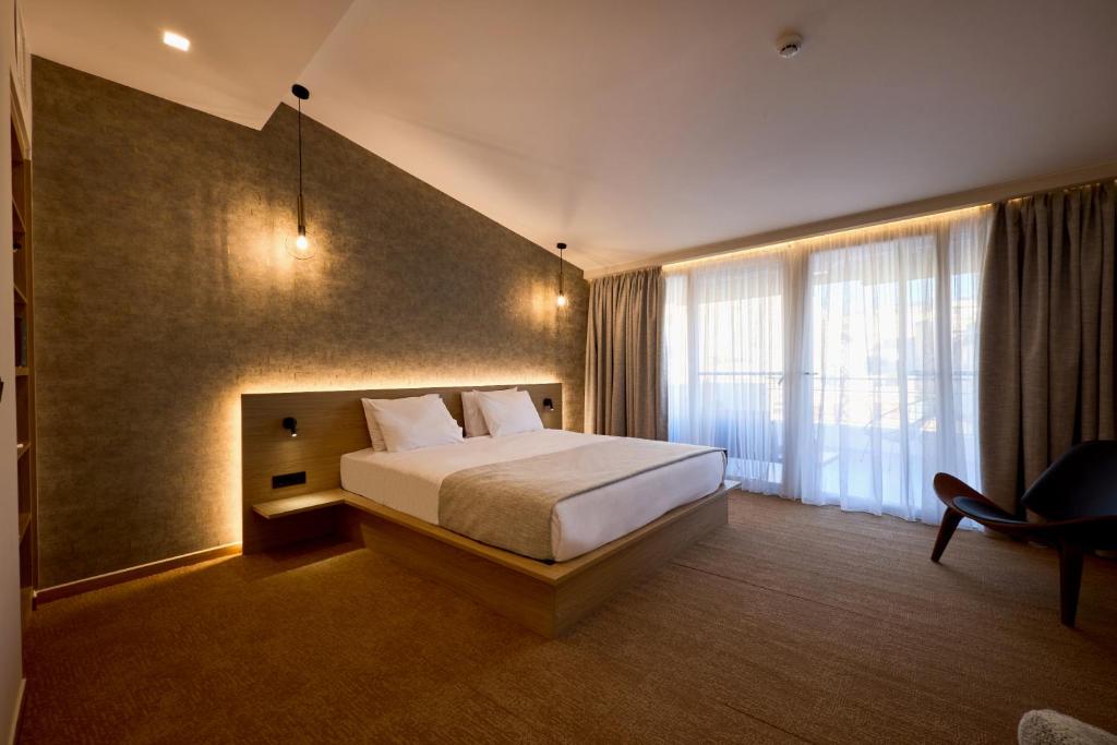 Postel nebo postele na pokoji v ubytování Athens City Suites
