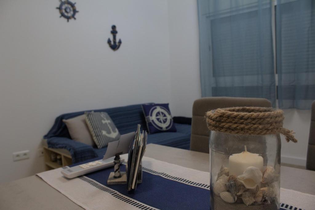 a living room with a table with a candle and a couch at Apartamento Encanto Marino in Sant Carles de la Ràpita