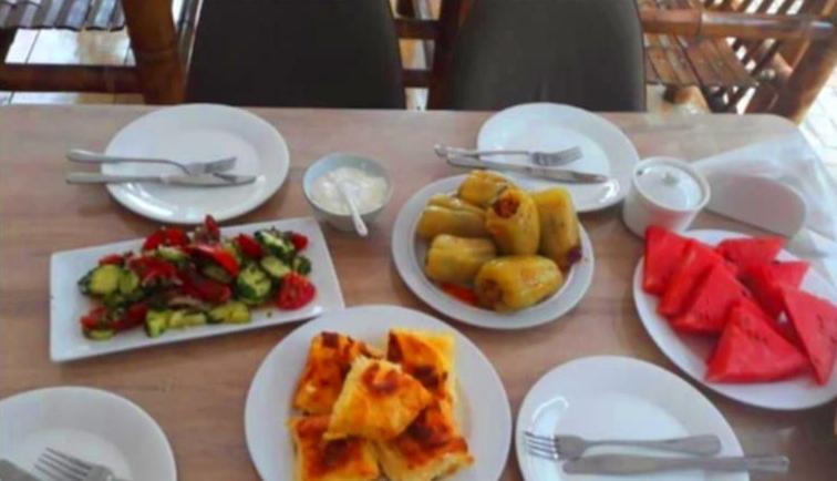 a table with white plates of food on it at Sunny days Kobuleti in Kobuleti