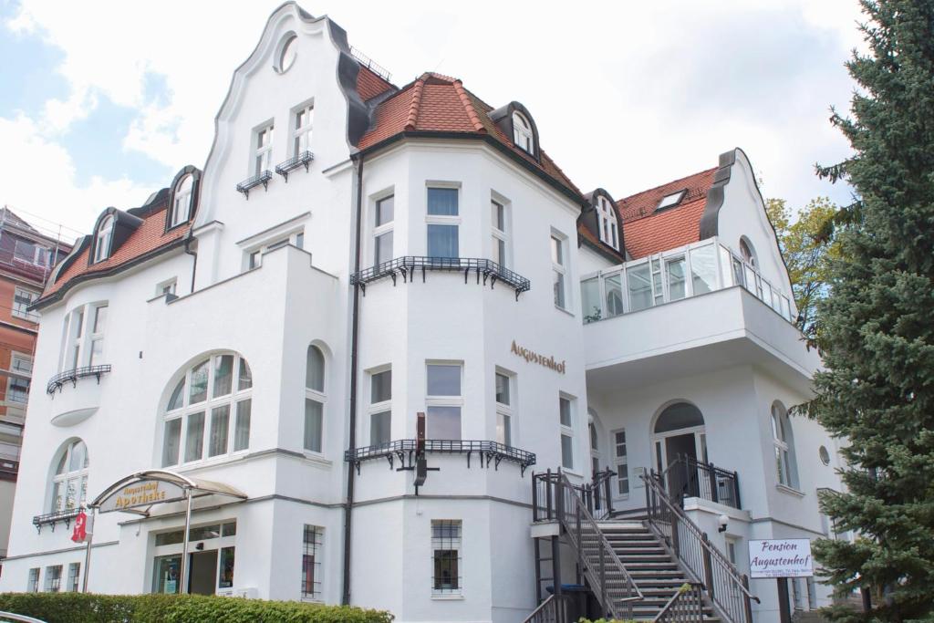 a white building with a red roof at Augustenhof in Bad Elster