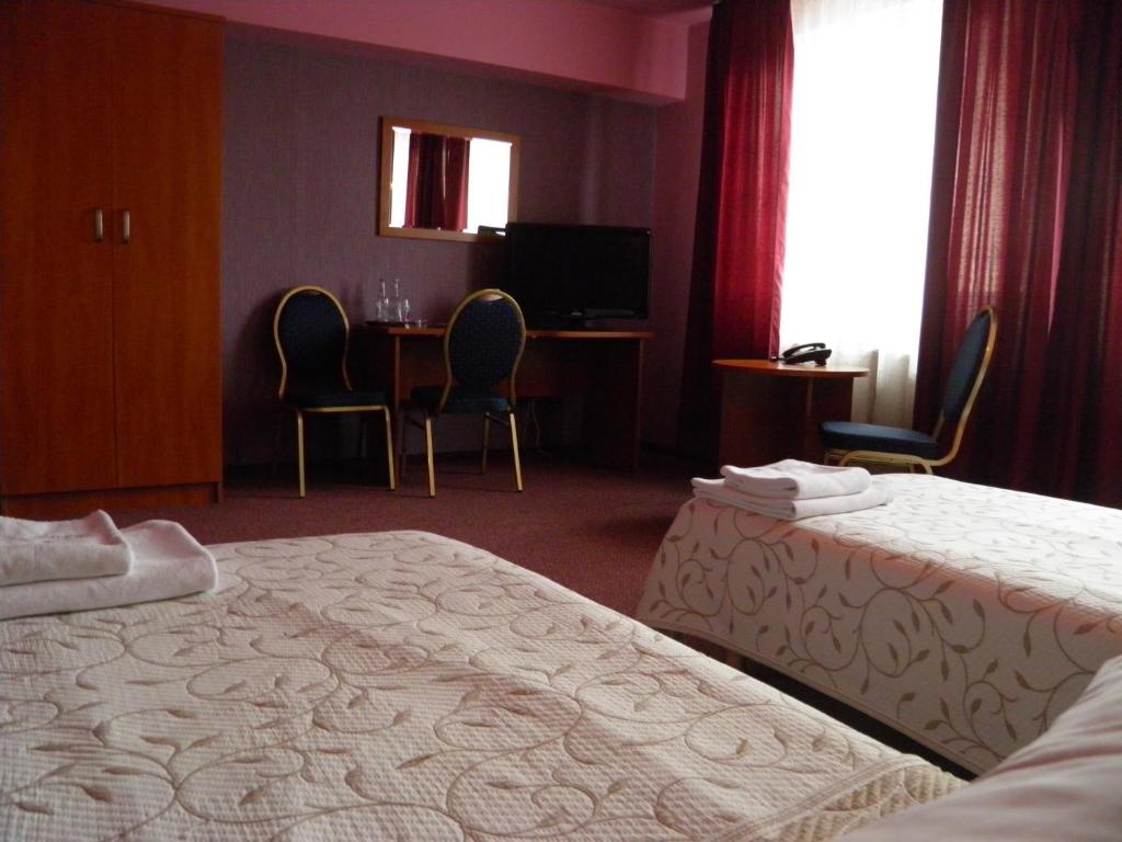 Posteľ alebo postele v izbe v ubytovaní Hotel Horyzont