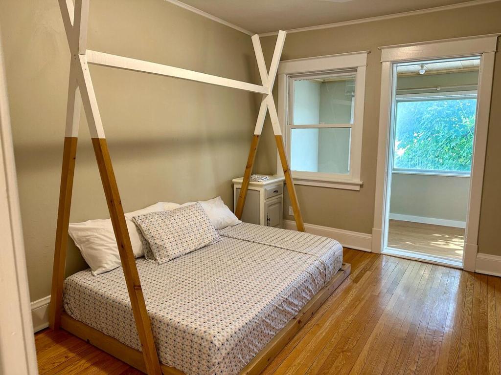 a bedroom with a bed with a four post canopy at The Dows retreat in Ottawa
