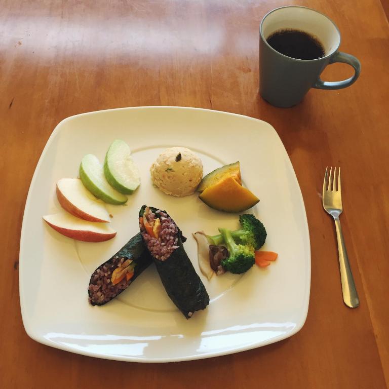 a plate of food with vegetables and a cup of coffee at Valley Silence B&amp;B in Ji&#39;an