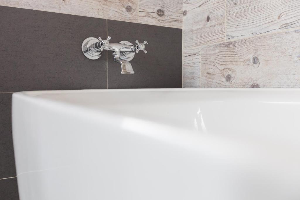 a bathroom with a white sink and a faucet at Valley Silence B&amp;B in Ji&#39;an