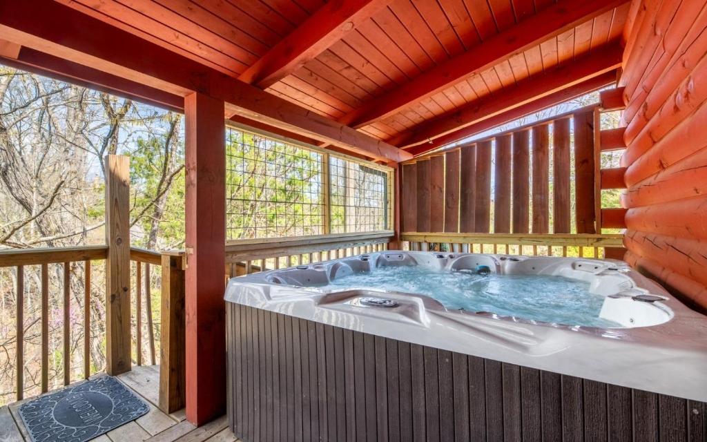 a jacuzzi tub on a deck in a house at Wanderlust in Sevierville